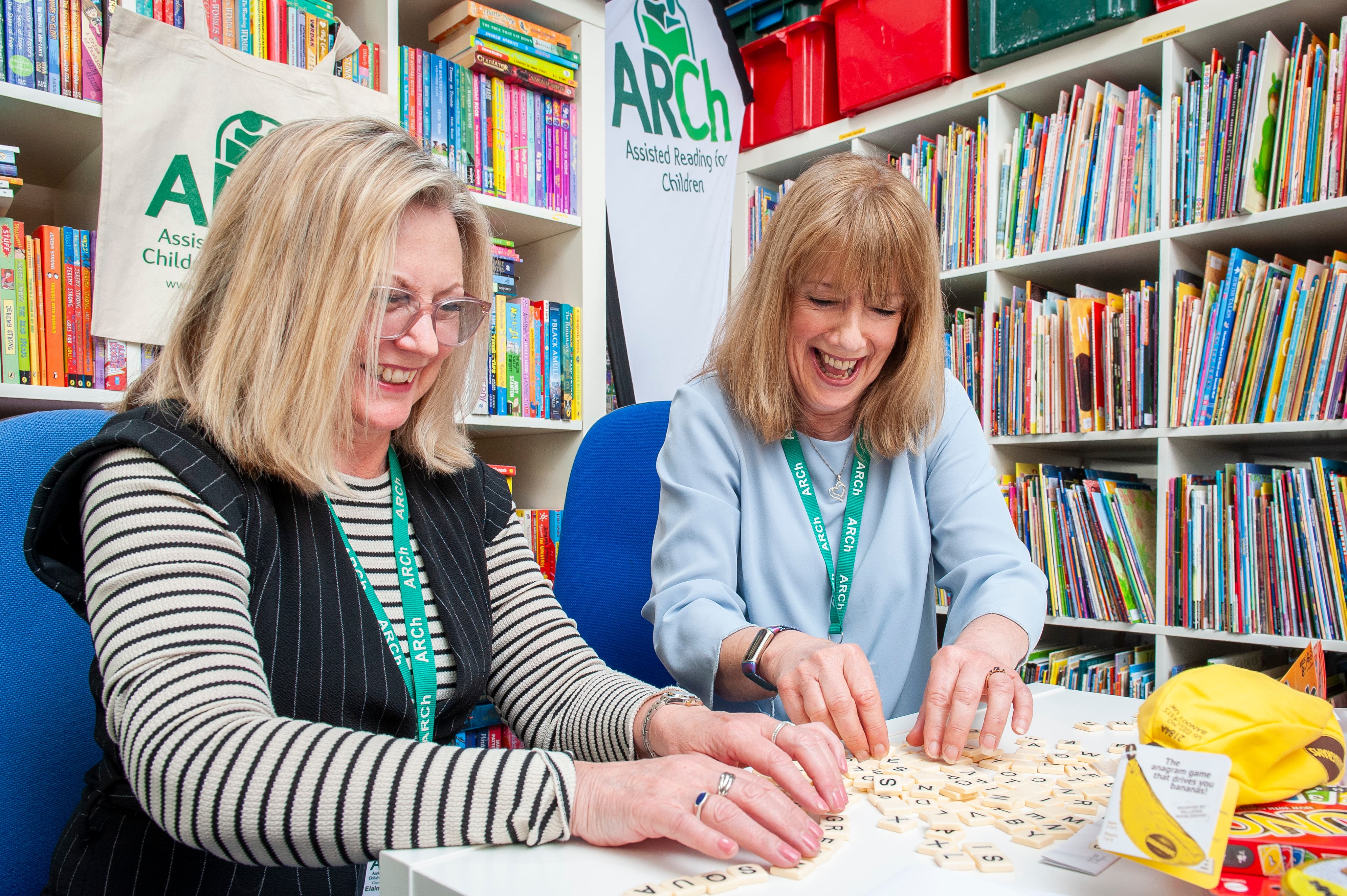 Two volunteers from ARCh playing board games